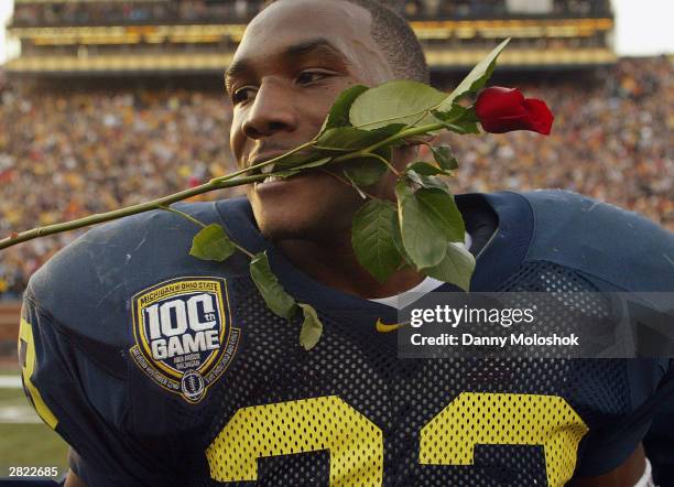 running-back-chris-perry-of-the-michigan-wolverines-celebrates-by-putting-a-rose-in-his-mouth.jpg